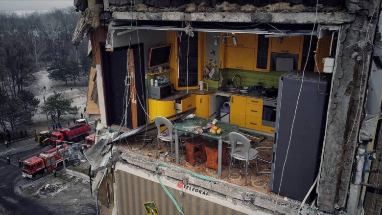 Photo of video | Imagine virală cu o bucătărie galbenă rămasă fără perete în blocul bombardat din Dnipro. Se văd mere pe masă și farfurii în chiuvetă